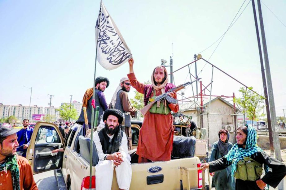 Taliban fighters seen on the back of a vehicle in Kabul, Afghanistan. Agency photo