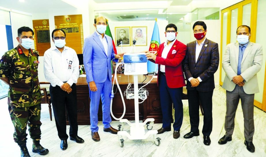 Dr. Mohammed Haider Ali Miah, Managing Director & CEO of Exim Bank Limited, handing over High-Flow Nasal Canola to DNCC's Mayor Md. Atiqul Islam for DNCC Dedicated Covid-19 Hospital at DNCC office in the capital on Wednesday. Md. Firoz Hossain, AMD of th