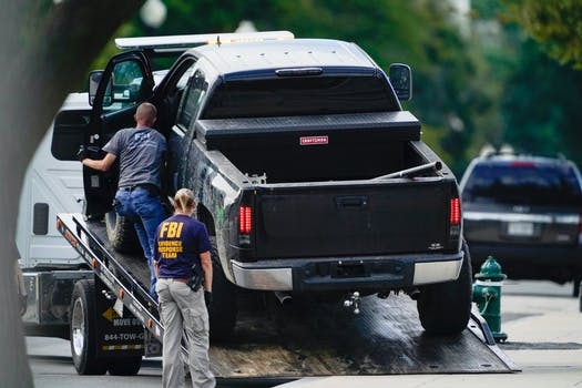Authorities get set to tow a pickup truck from the sidewalk in front of the Library of Congress’ Thomas Jefferson Building, Thursday, Aug. 19, 2021, in Washington.