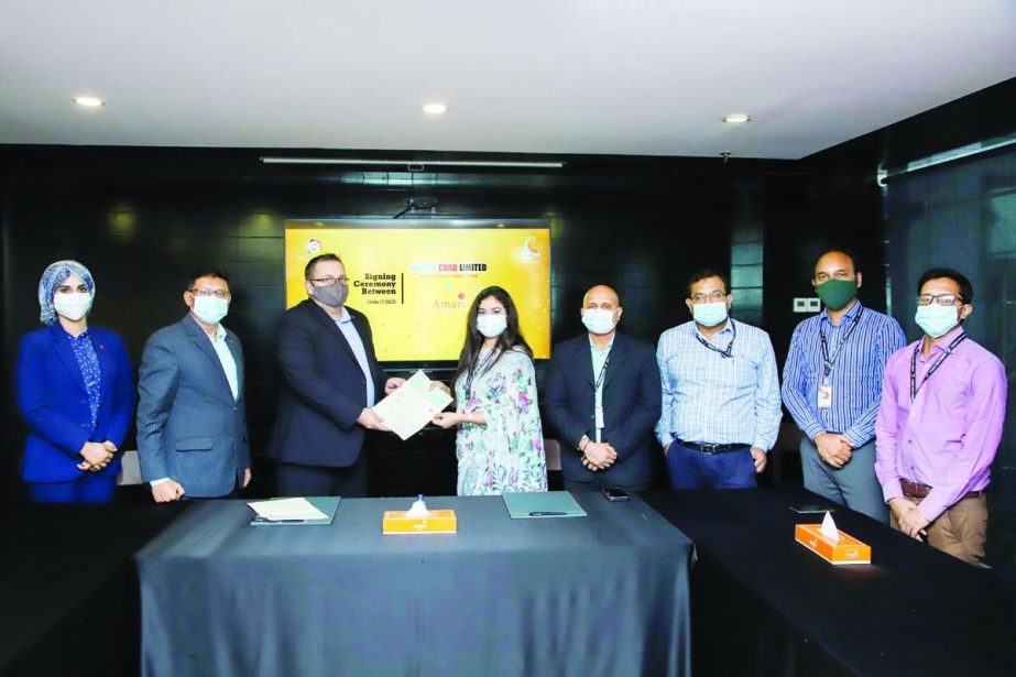 Jannatun Nahar, Executive Director of Alesha Card Limited and Christopher Baker, General Manager of Amari Dhaka Hotel, exchanging document after signing an agreement at the hotel in the capital recently. Under the deal, Alesha card holders will be able to