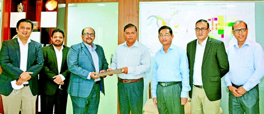 Officials of Ifad Autos and BEZA pose for photograph after a deal signing ceremony in Dhaka recently