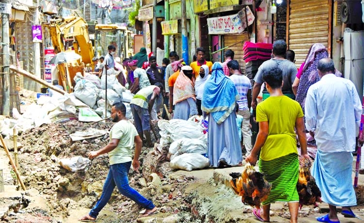 Unplanned and uncoordinated development works are carried out by different utility service providers resulting in severe hassle for plying of vehicles and movement of pedestrians. This photo was taken from Nazira bazaar area in Old Dhaka on Sunday.