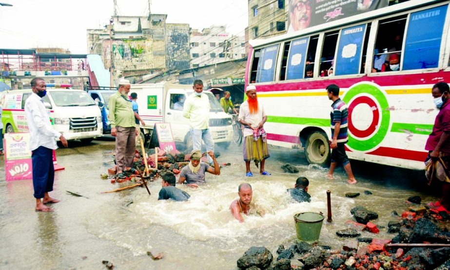 Workers doing repair works after a WASA water pipe burst at Nayabazar in the capital on Monday, causing long-tail back on the road.