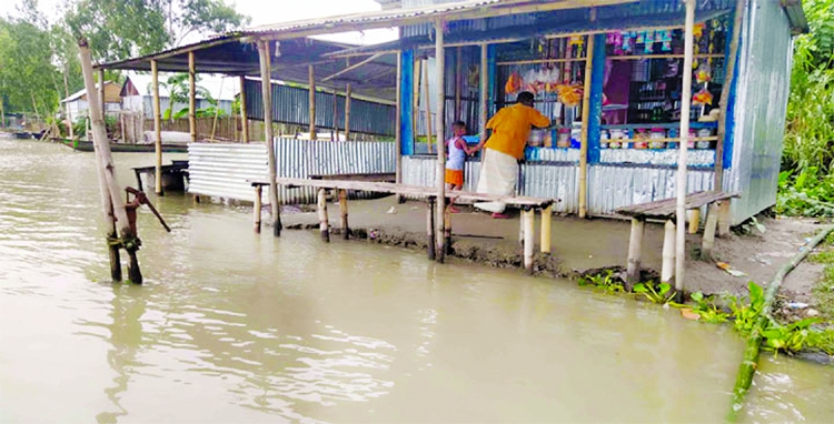 Vast areas of land in Kurigram district goes under flood water damaging standing crops and other valuables. This photo was taken from Zoragachh Bazar under Chilmari Upazila on Thursday.