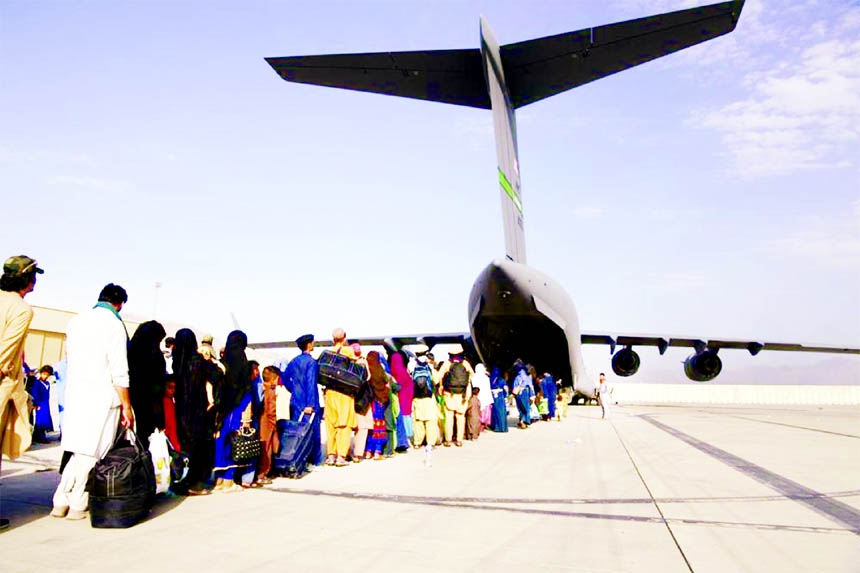 US Air Force loadmasters and pilots assigned to the 816th Expeditionary Airlift Squadron, load people being evacuated from Afghanistan onto a U.S. Air Force C-17 Globemaster III at Hamid Karzai International Airport in Kabul, Afghanistan.