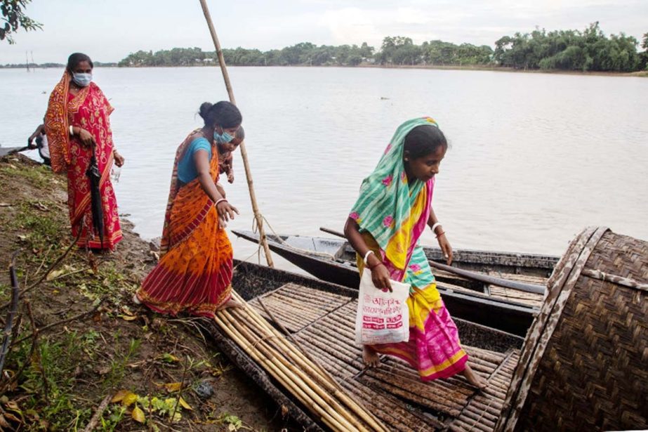 Villagers board a boat to cross the Pokoria river at Kaurhagi village in Morigaon district of Assam, India. Agency photo