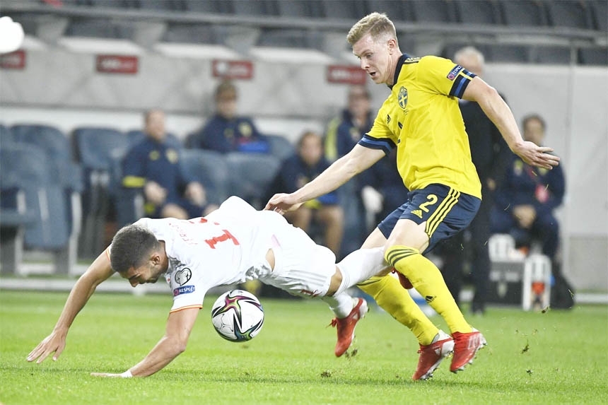 Spain's Carlos Soler (left) and Sweden's Emil Krafth vie for the ball during the World Cup 2022 group-B qualifying soccer match between Sweden and Spain at Friends Arena in Stockholm, Sweden on Thursday.