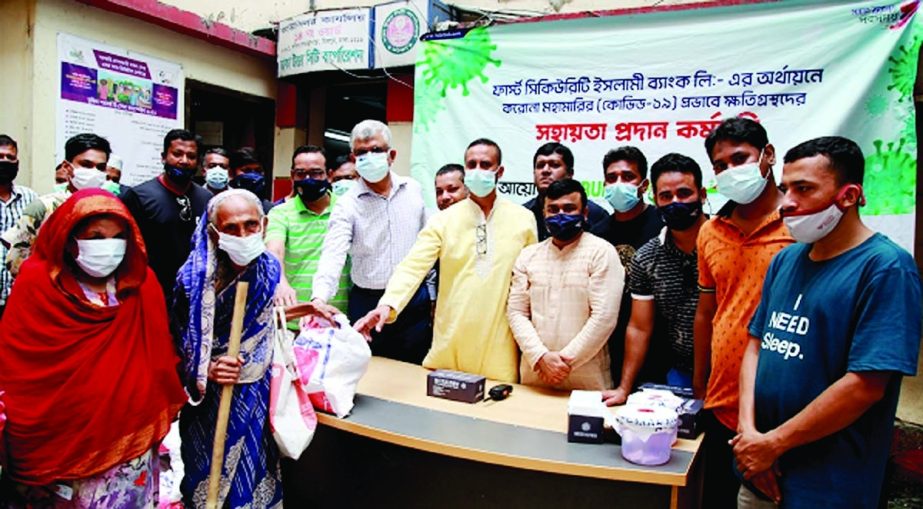 Khondhakar Shamim Ahmed, Dhaka North Zonal head of First Security Islami Bank Limited (FSIBL), distributing food assistance to the people distressed by corona virus at a function held at capital's Mirpur area recently. Senior officials of the bank and lo