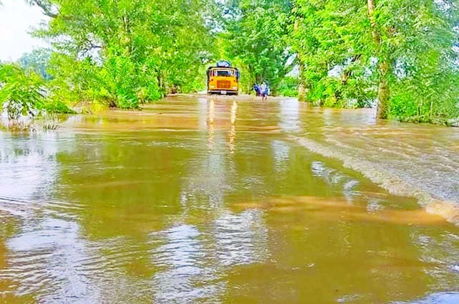 Many homes, crop lands and roads under Fulgazi upazila of Feni district have been inundated due to flash flood caused by heavy rainfall and onrush of water from the upper catchment in India. This photo taken on Monday shows water overflows a road and the