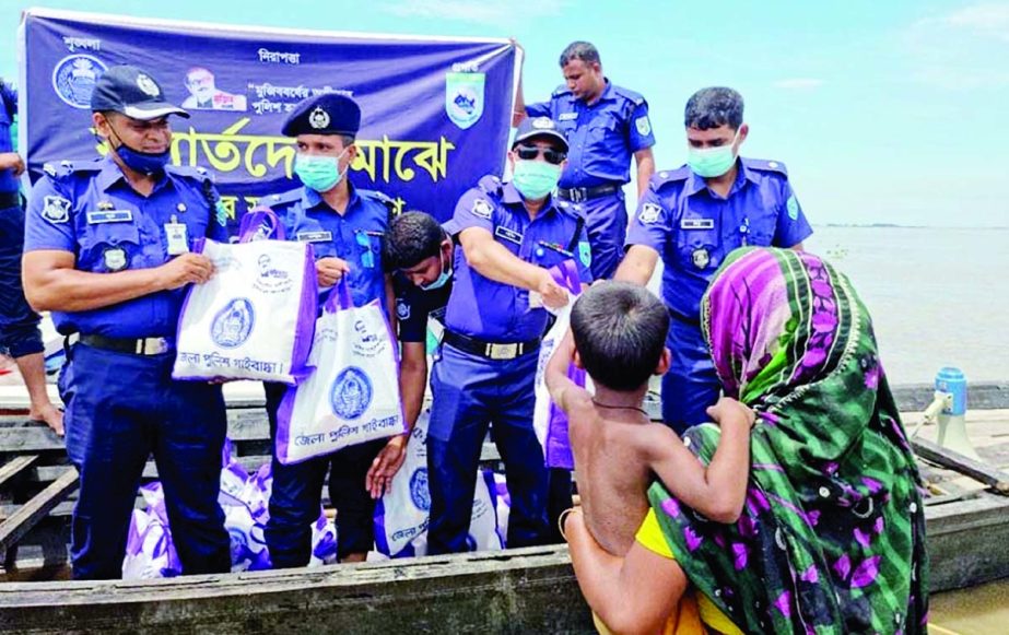 Superintendent of Police (SP) Muhammad Towhidul Islam formally distributes food materials among over 200 flood affected people of different char areas of Fulchhari upazila in Gaibandha district on Tuesday. Additional SP-B circle Abu Laichh Md. Illias Ziku