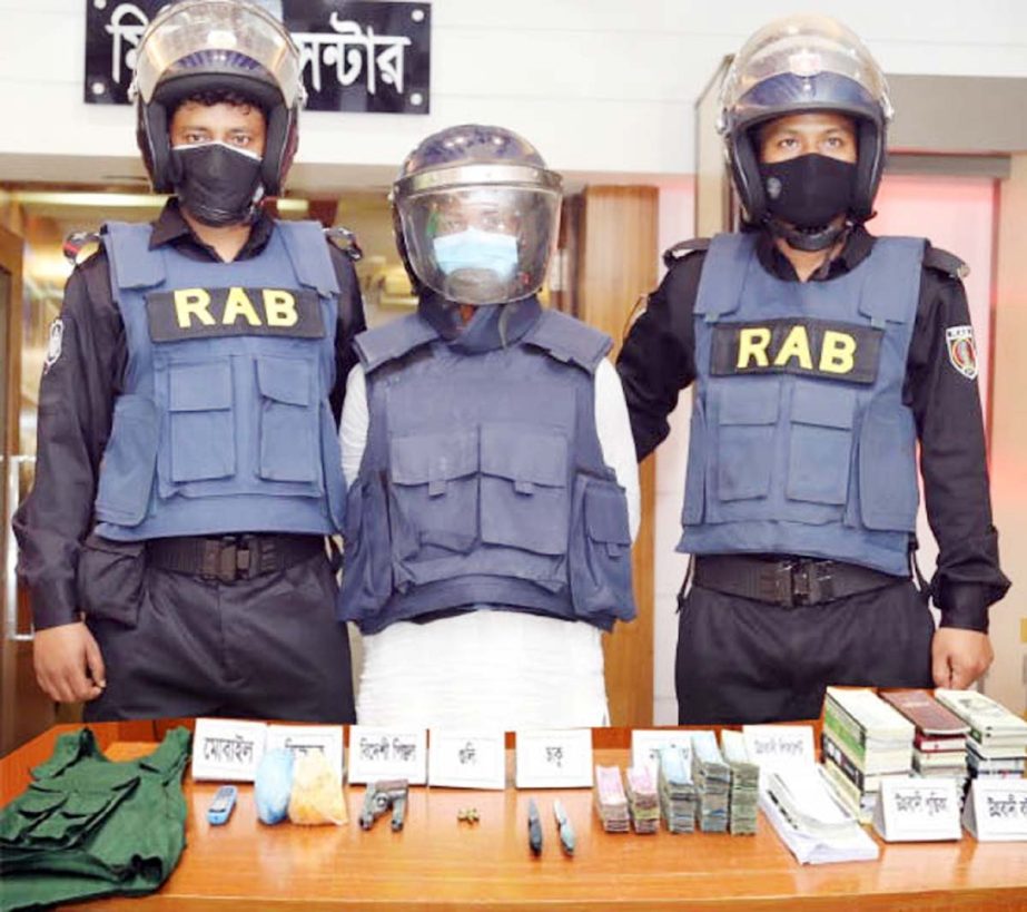 RAB detains a leader of outfit organisation Emdadul with arms and ammunition conduting raid in the city's Basila area on Thursday. NN photo