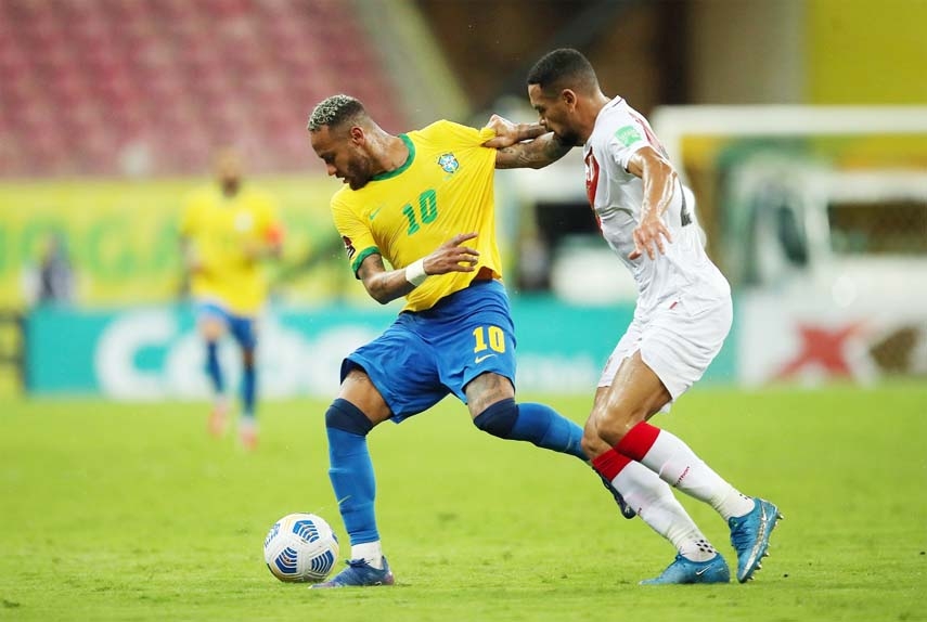 Brazil's Neymar (left) is seen in action against Peru's Alexander Callens during their World Cup qualifying match at the Arena Pernambuco, Sao Lourenco da Mata, Brazil on Thursday.