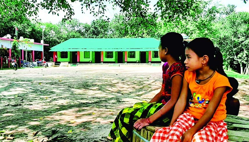 Like other places of the country, schools in the hilly zones of Bangladesh are also preparing to reopen tomorrow. In this photo, two tender-hearted tribal students are seen eagerly waiting to get back to their classroom again. This snap was taken from Son