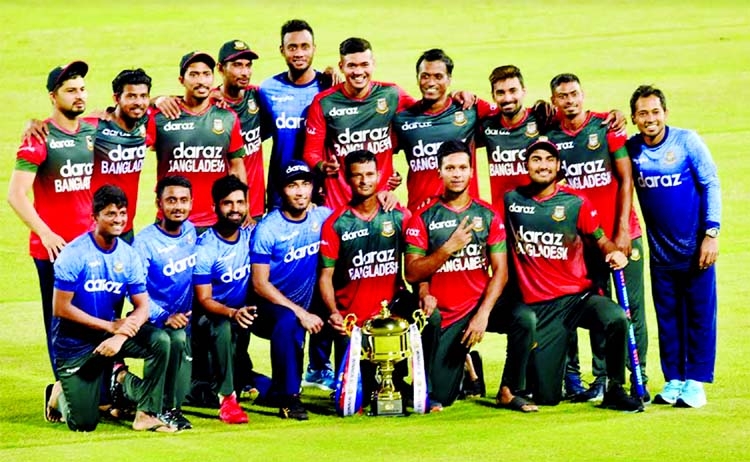 Bangladesh Cricketers pose with the trophy after winning the five-match Twenty20 International series against New Zealand at the Sher-e-Bangla National Cricket Stadium in the city's Mirpur on Friday.