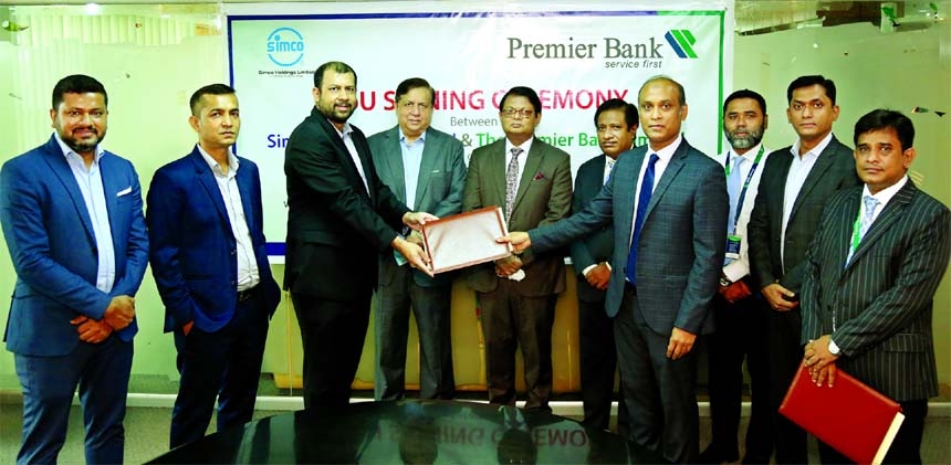 Mohammad Shamim Murshed, Head of Retail Banking Division of Premier Bank Limited and Khurrum Siddique, Managing Director of Simco Holdings Limited, exchanging document after signing an agreement on behalf of their respective organizations. Under the deal,