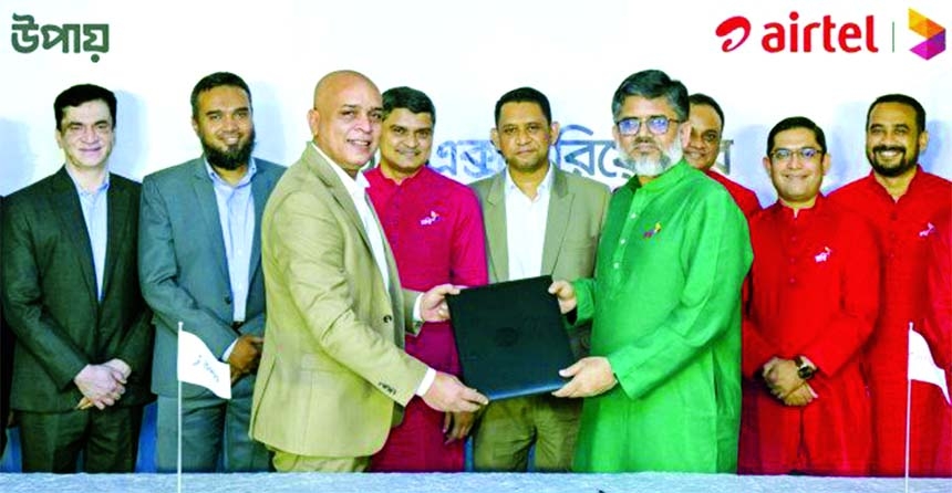 Sydul H Khandaker, Managing Director and CEO of upay and Shihab Ahmad, Chief Commercial Oficer of Robi Axiata Limited, exchanging document after signing an agreement on behalf of their respective organisations at a city hotel on Monday.Top officials from