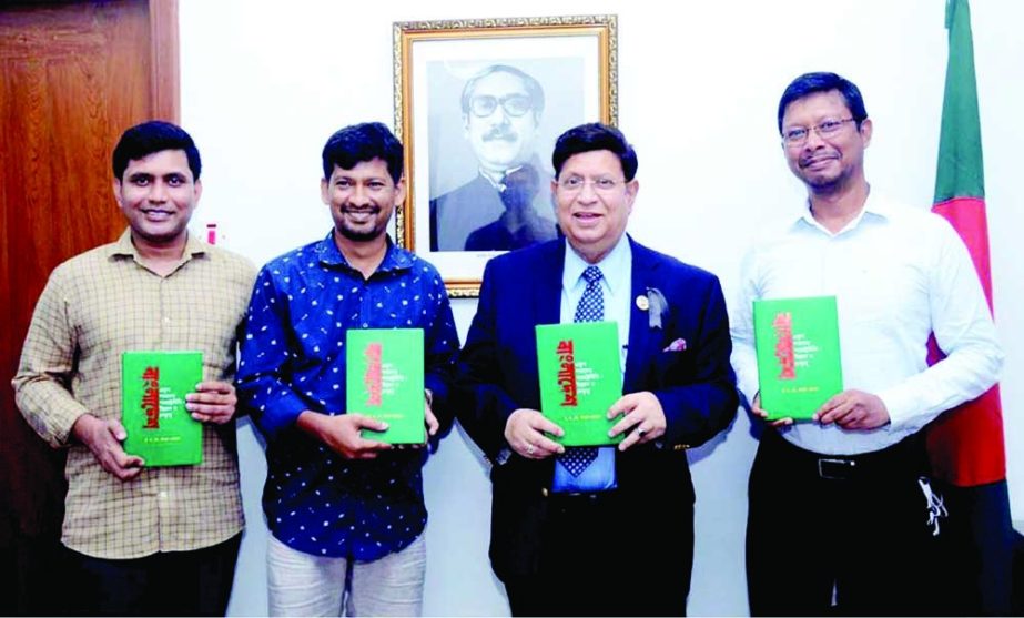 Foreign Minister Dr A K Abdul Momen unveils the book named 'Bangladesh-Ekush Shotoker Pororastroniti: Unnoyon O Netritto' at his Ministry office on Monday. NN photo