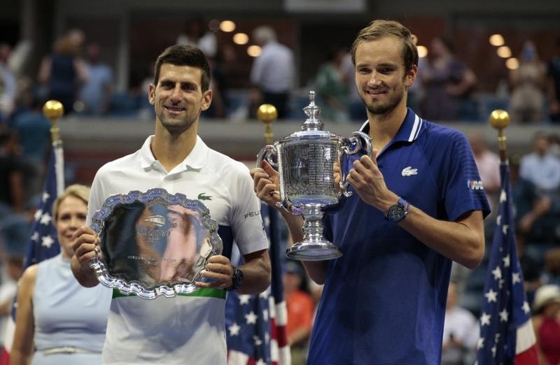 Winner Russia's Daniil Medvedev (right) and Serbia's Novak Djokovic hold their trophies after the 2021 US Open Tennis tournament men's final match at the USTA Billie Jean King National Tennis Center in New York on Sunday. Agency photo