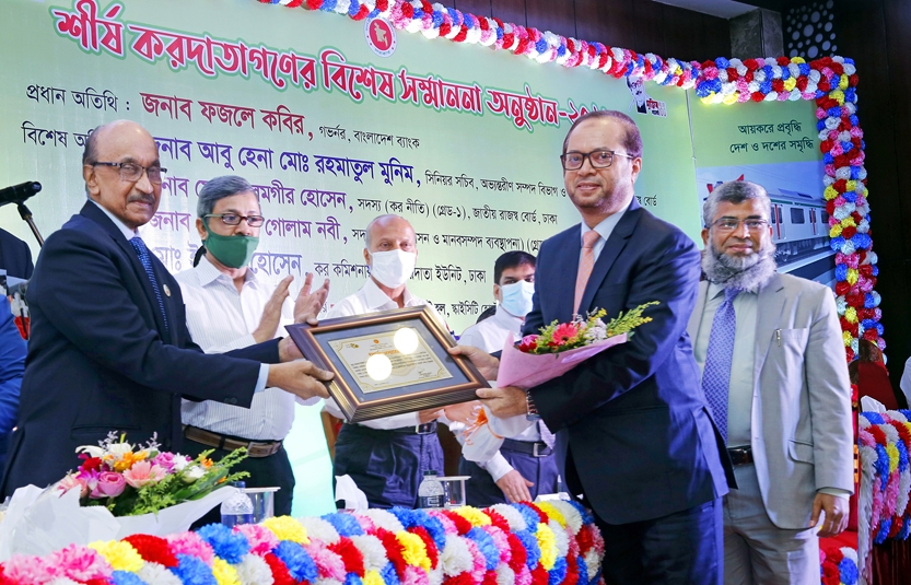 Mohammed Monirul Moula, Managing Director and CEO of Islami Bank Bangladesh Limited, receiving letter of recognition of highest taxpayers in banking sector for 2020-21 fiscal year from Fazle Kabir, Governor of Bangladesh Bank at in a city hotel in the cap