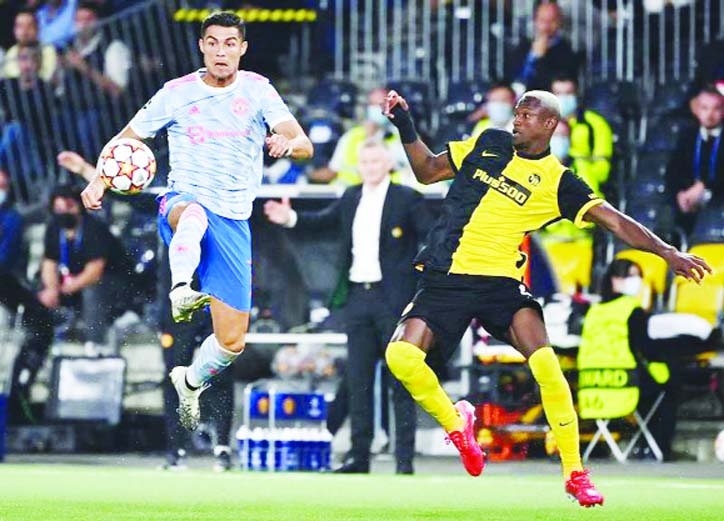 Manchester United's striker Cristiano Ronaldo (left) fights for the ball with Young Boys' defender Mohamed Ali Camara during the UEFA Champions League Group F football match at Wankdorf stadium in Bern on Tuesday.