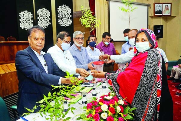 Secretary (Routine work) of the Ministry of Agriculture Dr. Md. Abdur Rauf distributes organic pesticides and Neem saplings among the trainee farmers as chief guest at a training workshops for safe food production titled "Effective Insect Control of Vari"