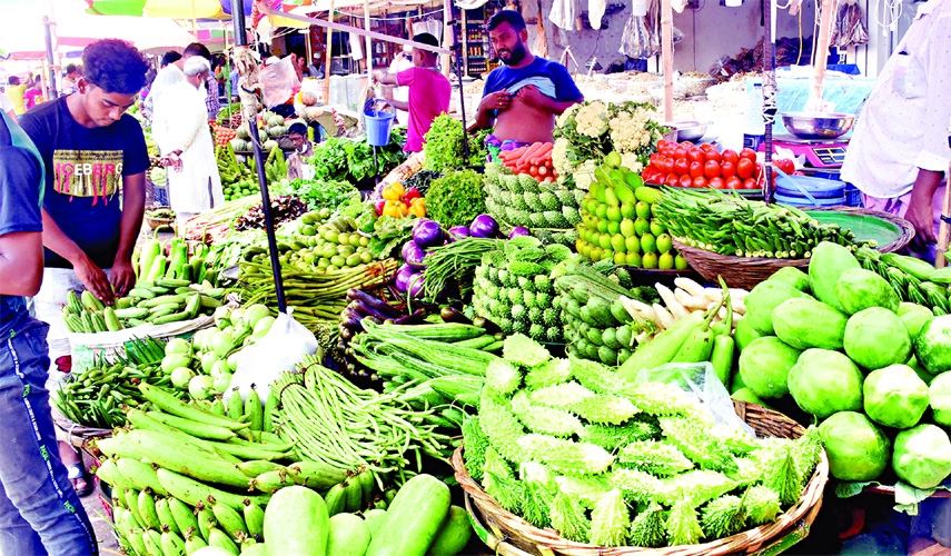 Vendors sell vegetables at Karwan Bazar in the capital on Friday amid price hike of daily essentials.