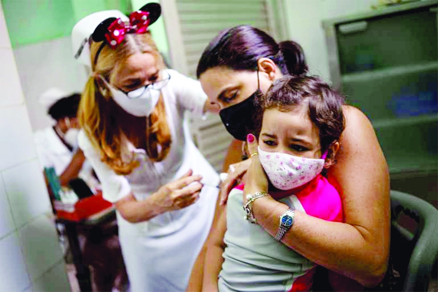 A mother holds her daughter who is injected with a dose of the Soberana-02 Covid-19 vaccine in Havana, Cuba on Friday.