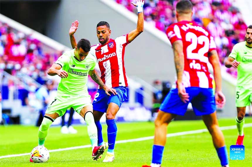 Atletico de Madrid's Renan Lodi (right) vies with Bilbao's Alex Berenguer during a Spanish first division league football match between Atletico de Madrid and Athletic Club Bilbao in Madrid, Spain on Saturday. Agency photo