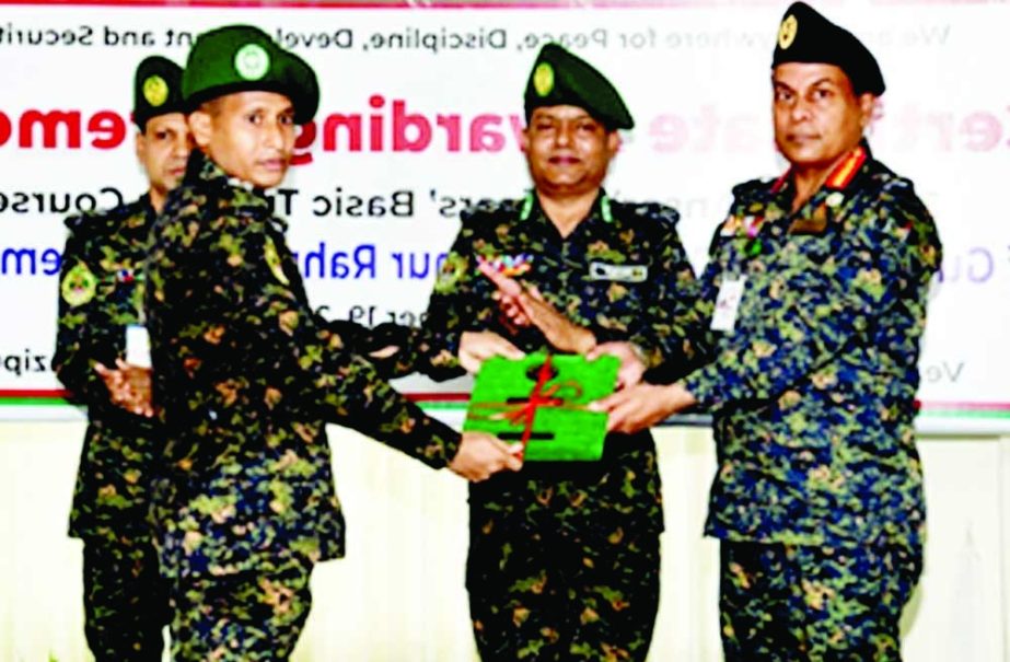 DG of Ansar-VDP Academy Major General Mizanur Rahman Shamim, ndc distributes awards among the successful trainees of fundamental training of the 37th BCS officials on the academy premises in Shafipur on Sunday. NN photo