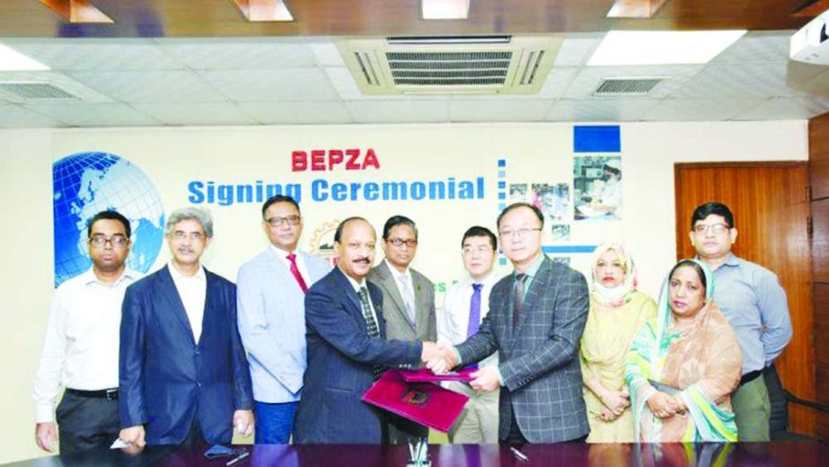 Ali Reza Mazid, Member (Investment Promotion) of Export Processing Zones Authority (BEPZA) and Chen Shu Qiang, Senior Operation Manager of Meigo (BD) Limited, exchanging document after signing an agreement on behalf of their respective organizations at BE