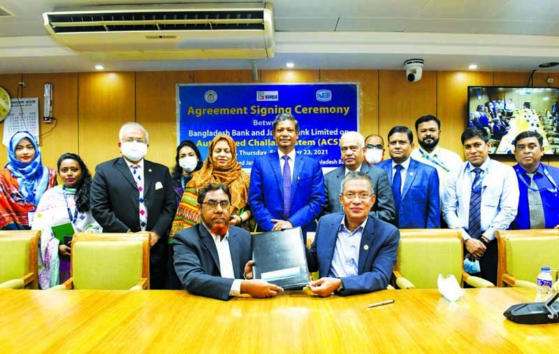 Md.Abdus Salam Azad, MD and CEO, Janata Bank Limited and Md. Forkan Hossain, General Manager of Bangladesh Bank (BB), exchanging document after signing a MoU on Automated Challan System (ACS) at BB head office in the capital recently. Ahmed Jamal, Deputy