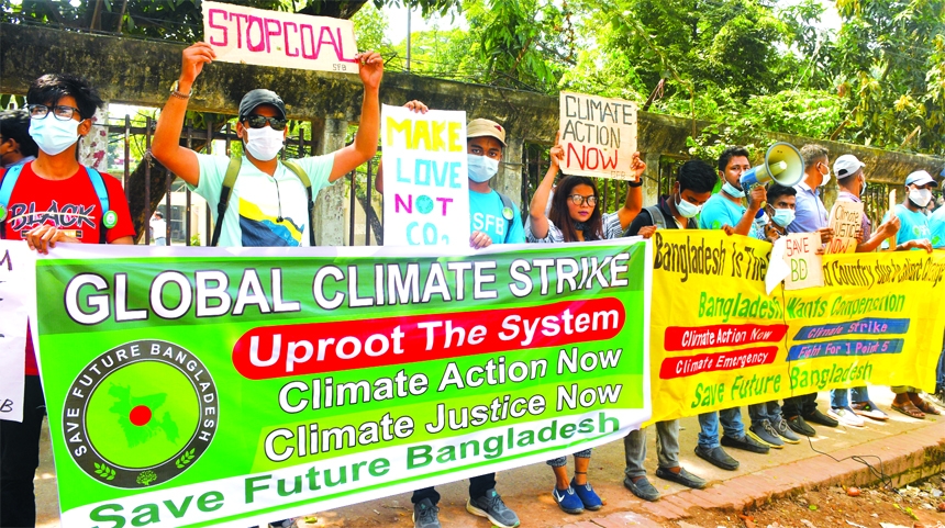 Environmental activists stage a rally in front of the National Press Club in the capital on Friday, seeking global actions to curb adverse impact of climate change.
