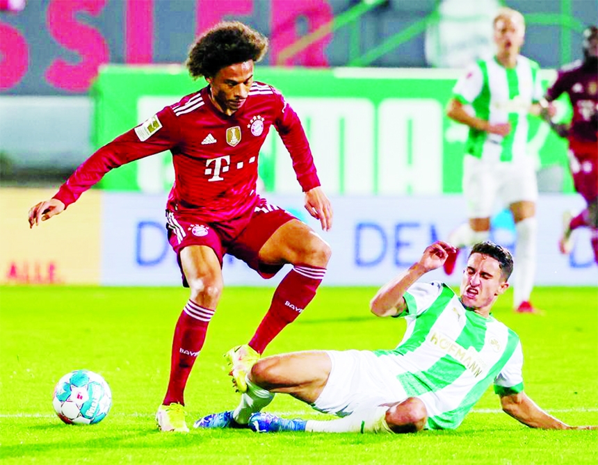 Leroy Sane (left) of Bayern Munich vies with Marco Meyerhoefer of Fuerth during a German Bundesliga match between SpVgg Greuther Fuerth and Bayern Munich in Fuerth, Germany on Friday.