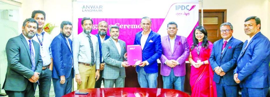 Mominul Islam, Managing Director and CEO of IPDC Finance Limited and Hossain Khaled, Managing Director of Anwar Landmark Limited, exchanging document after signing an agreement at IPDC Finance head office in the capital on Sunday. Under the deal, customer