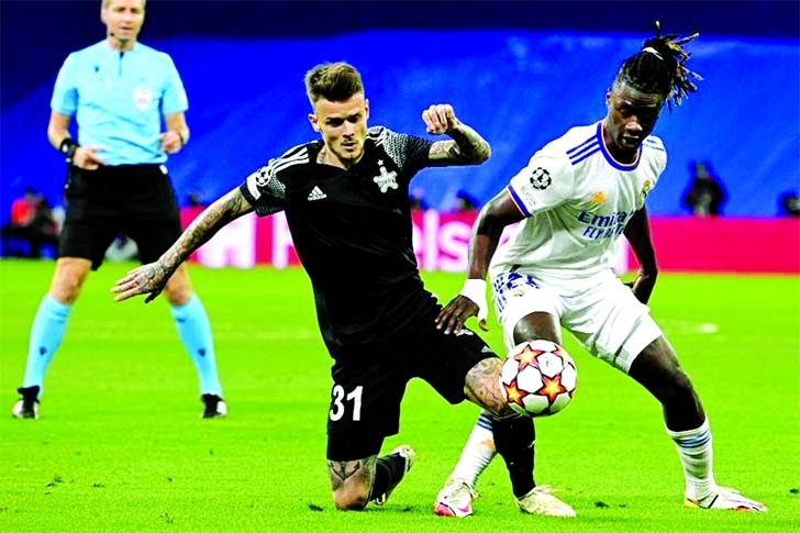 Sheriff's midfielder Sebastien Thill vies with Real Madrid's midfielder Eduardo Camavinga (right) during their UEFA Champions League first round group D football match at the Santiago Bernabeu stadium in Madrid on Tuesday.