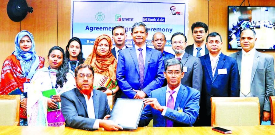 Md. Arfan Ali, President & Managing Director of Bank Asia Limited and Forkan Hossain, General Manager of Accounts & Budgeting Department of Bangladesh Bank (BB), exchanging document after signing an agreement at BB head office in the capital recently to p