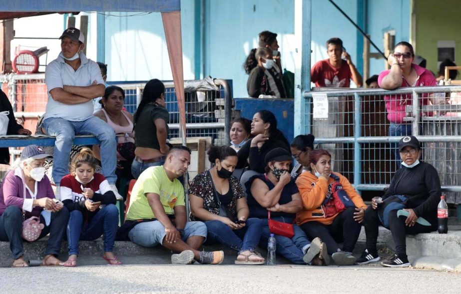 Relatives of prisoners await news outside the Litoral Penitentiary in Guayaquil, Ecuador, Wednesday, September 29, 2021. The authorities report at least 100 dead and 52 injured during a riot on Tuesday at the prison.