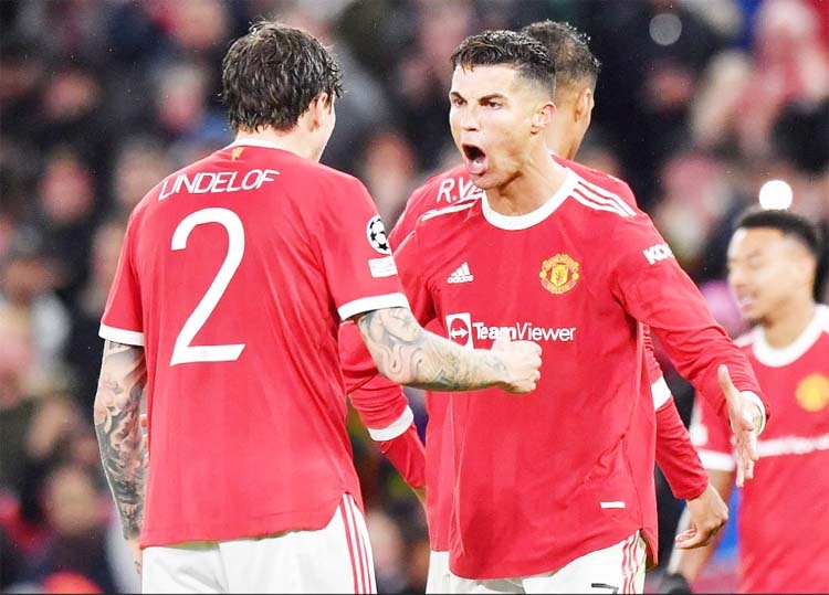 Manchester United's striker Cristiano Ronaldo (right) celebrates with Manchester United's defender Victor Lindelof at the final whistle in the UEFA Champions league group F football match against Villarreal at Old Trafford stadium in Manchester, England