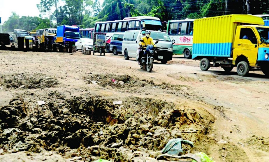 Vehicles struggle to move on the Tongi-Cherag Ali road in Gazipur as a portion of the road got completely damaged due to implementation of the Bus Rapid Transit (BRT) road. NN photo