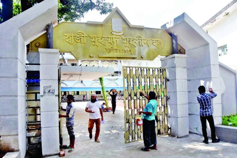 Workers cleaning the entrance of the Hazi Muhammad Mohsin residential hall of Dhaka University on Thursday as the dormitories prepare to welcome students back after 18-month of closures due to the coronavirus pandemic. NN photo