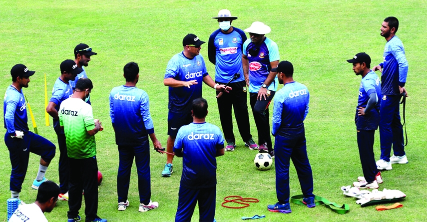 File photo of Bangladesh cricket team and coaching staff members huddling up during training in Mirpur.