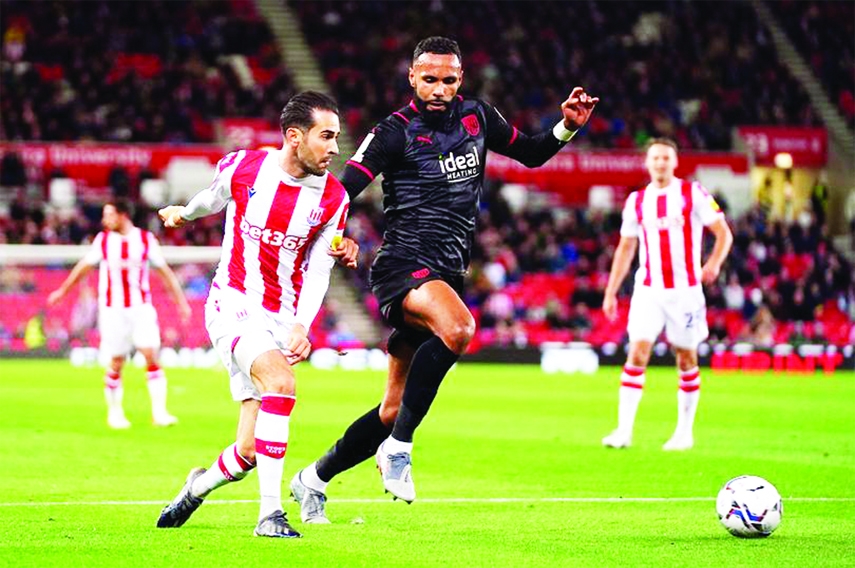 Stoke City's Mario Vrancic (left)shoots under pressure from West Bromwich Albion's Kyle Bartley during the Sky Bet Championship match at the bet365 Stadium on Friday.