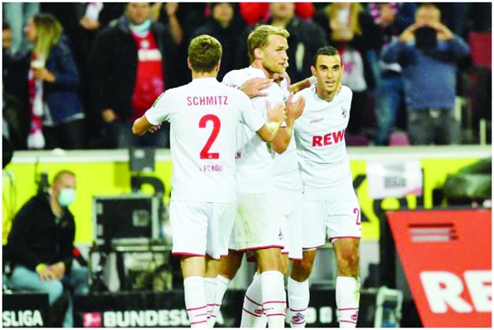 Cologne players celebrate one of their goals against Furth in Bundesliga. during the German Bundesliga soccer match between FC Cologne and Greuther Furth on Friday.