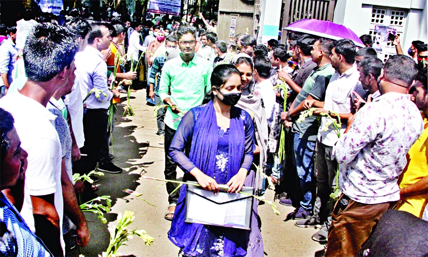 General students greet Dhaka University examinees with flowers who appeared at 'Kha' unit admission test on Saturday.