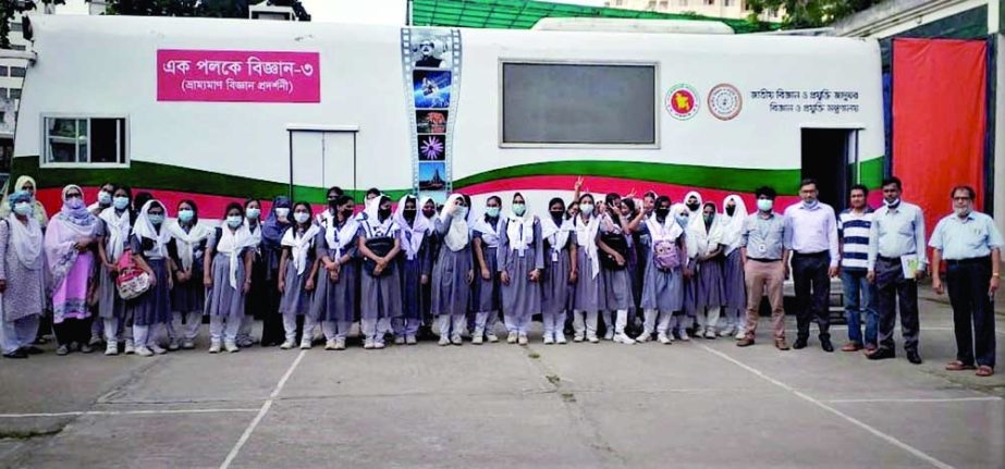 DG of National Science and Technology Museum Munir Chowdhury poses for a photograph with the participants in science lecture on the premises of the museum in the city on Tuesday marking International Day for Children. NN photo