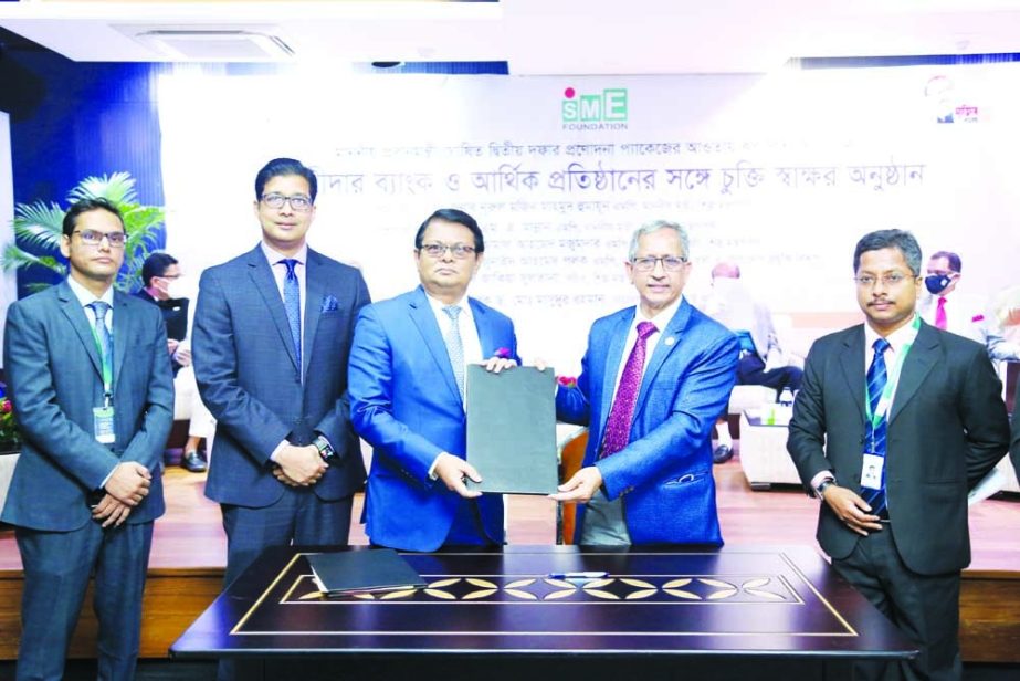 M. Reazul Karim, Managing Director & CEO of Premier Bank Limited and Dr. Md. Mafizur Rahman, Managing Director of SME Foundation, exchanging document after signing an agreement for providing loan facility to the SME Business in rural and sub urban area of
