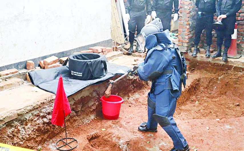 A Rapid Action Battalion (RAB) member disposes of a mortar shell found at the Zoo Road of Mirpur in the capital on Wednesday while digging soil for building construction.