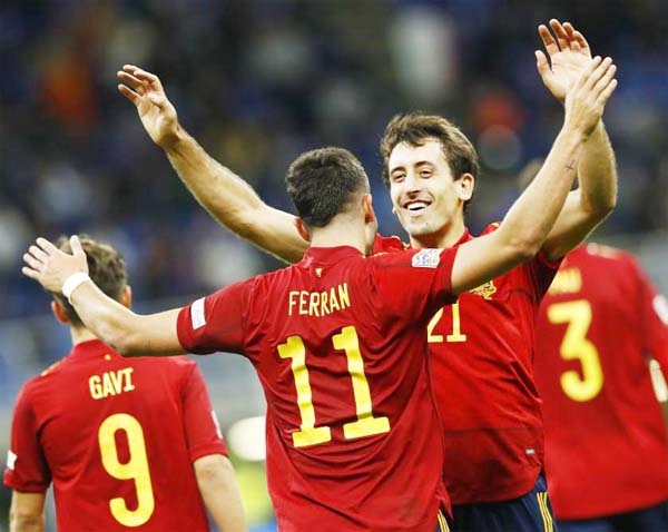 Spain's Ferran Torres (front) celebrates his goal with his teammate Mikel Oyarzabal during their UEFA Nations League semifinal against Italy in Milan, Italy on Wednesday.