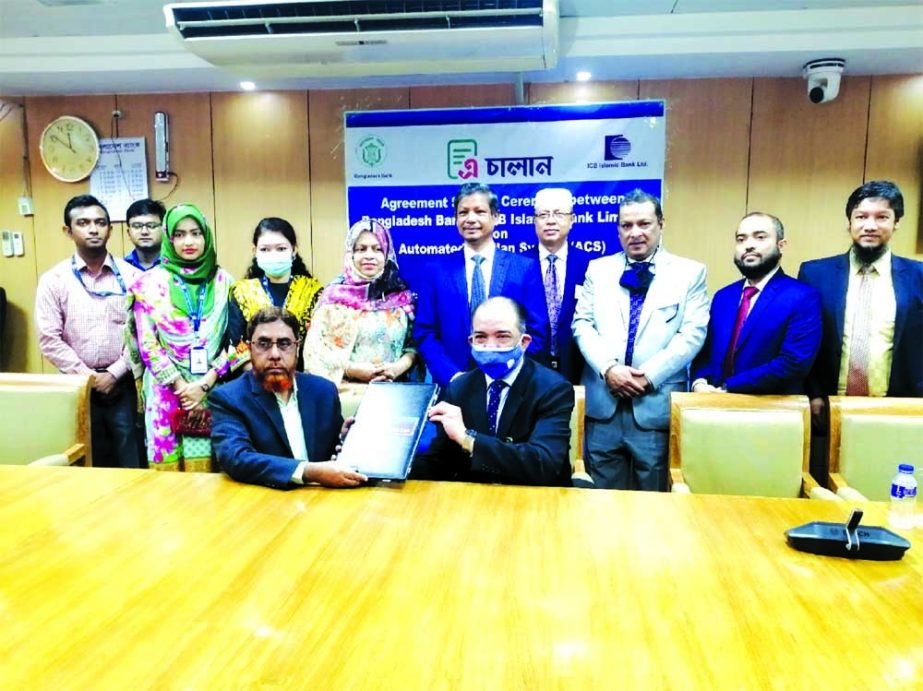 Muhammad Shafiq Bin Abdullah, Managing Director of ICB Islamic Bank Limited (ICBIBL) and Forkan Hossain, General Manager of Bangladesh Bank (BB), exchanging document after signing an agreement Automated Challan System (ACS) at BB head office in the capita