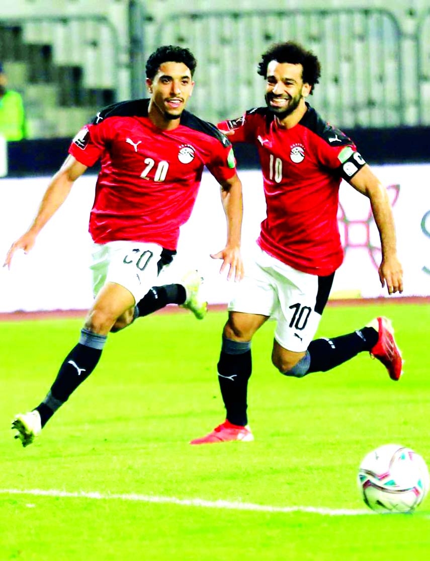 Mohamed Salah (right) and Omar Marmoush of Egypt celebrate during the FIFA 2022 World Cup qualifier match between Egypt and Libya in Alexandria, Egypt, on Friday.
